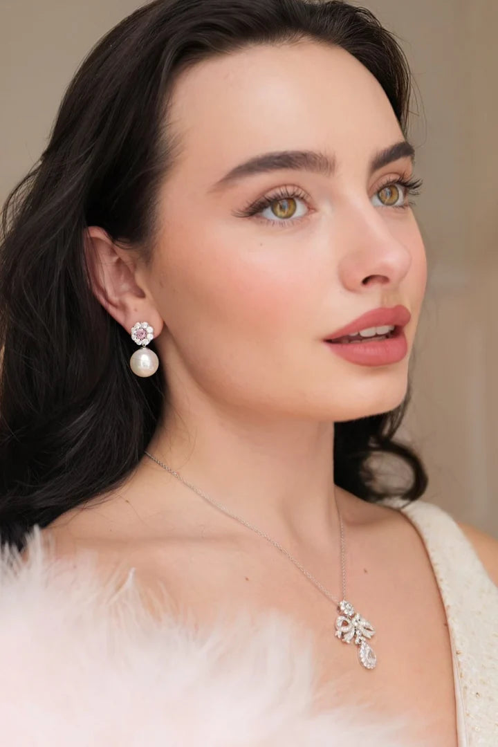 Silver-toned drop earring: flower stud with pink and clear crystals, large white pearl drop.