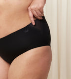 Third model close-up view of the Triumph Flex Smart black maxi panty, highlighting the high-waisted coverage and smooth, seamless fabric. Available Online at Blue Salon Qatar