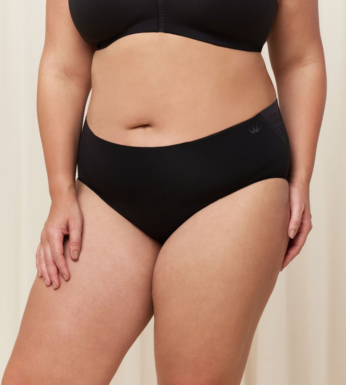 Third model front view of the Triumph Flex Smart black maxi panty, highlighting the high-waisted coverage and smooth, seamless fabric. Available Online at Blue Salon Qatar