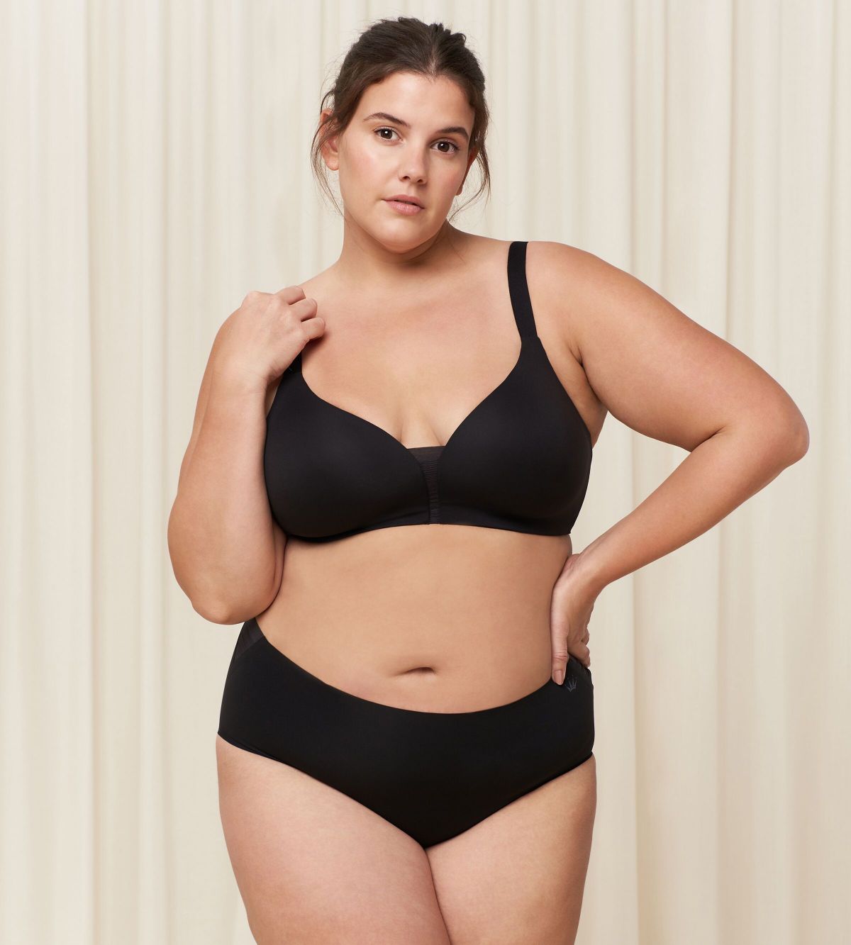 Third model full front view of the Triumph Flex Smart black maxi panty, highlighting the high-waisted coverage and smooth, seamless fabric. Available Online at Blue Salon Qatar