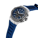 A three-quarter profile studio view of the Cerruti 1881 Lucardo watch, highlighting the depth of the angular silver steel case, the knurled crown, side pushers, and the integrated blue silicone strap connection.