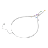 A three-quarter perspective studio view of the Ariana Grande x Swarovski dragonfly necklace, highlighting the dimensional layering of the crossover strands and the brilliant sparkle of the colorful mixed-cut crystals.