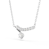 A three-quarter perspective studio view of the Swarovski Matrix curved necklace, demonstrating the dimensional layering of the crystal-lined arch and the hanging round-cut crystal drop.