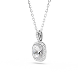 A three-quarter perspective studio view of the Swarovski Una Angelic pendant, illustrating the dimensional depth of the setting, the brilliant faceting of the central cushion-cut stone, and the crystal-lined bail.