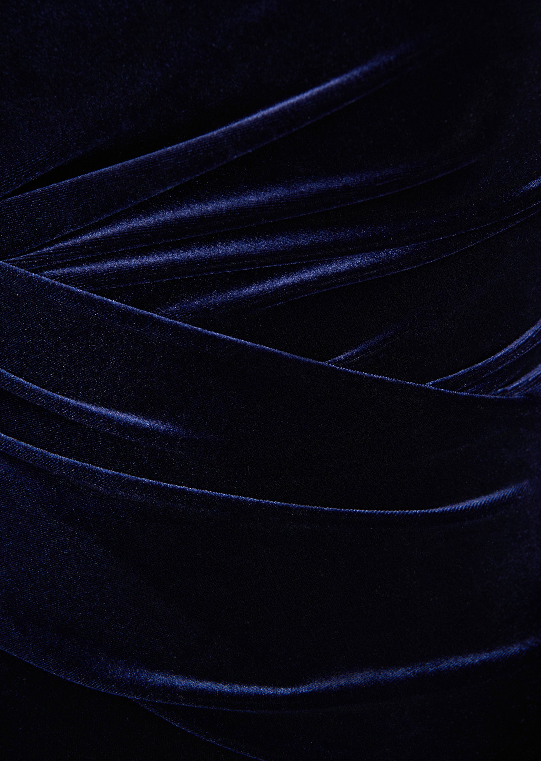 Navy velvet long dress with elegant draping and soft, flowing folds.