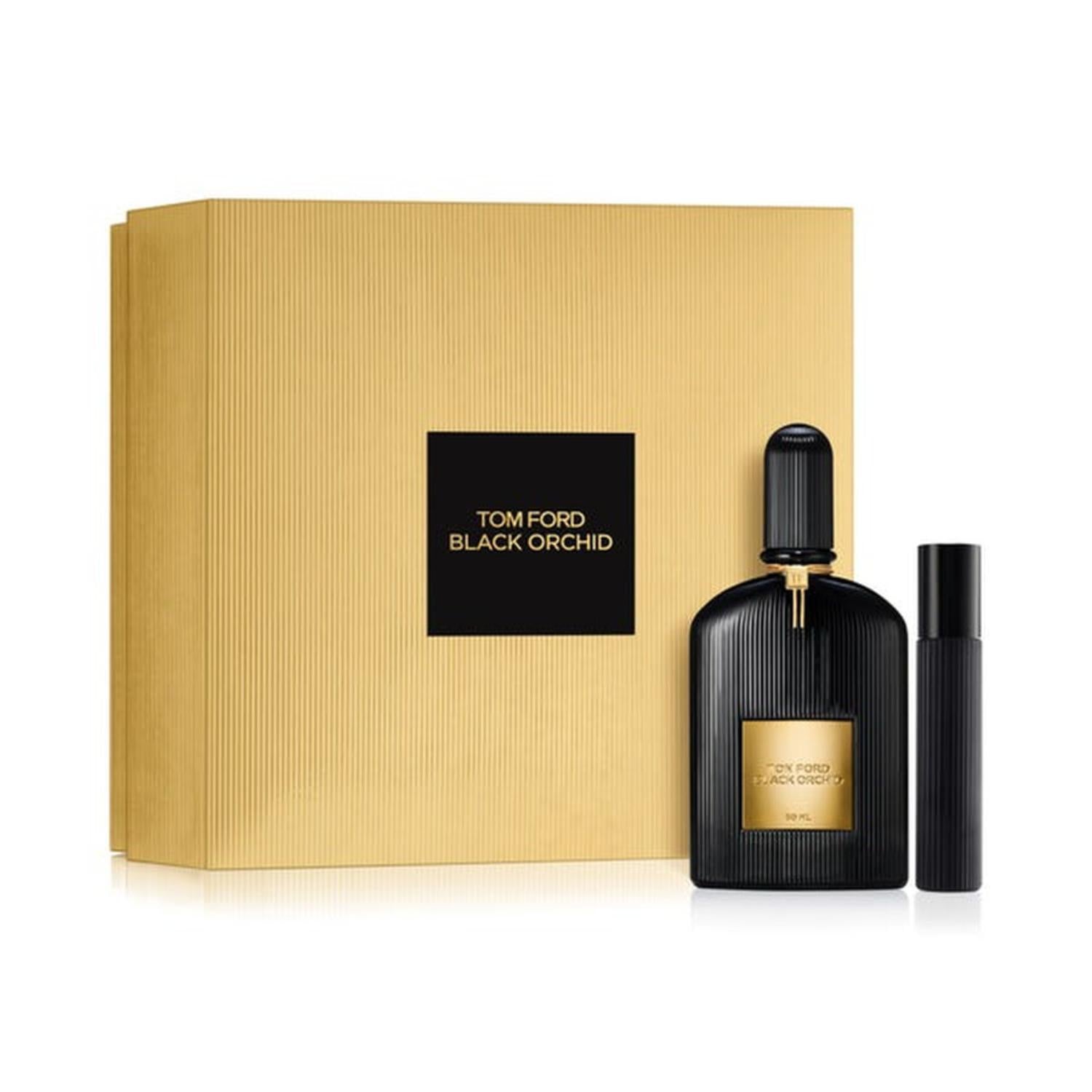 Tom Ford Black Orchid gift set featuring a large ribbed gold presentation box with a black logo square, a ribbed black 50ml perfume flacon with a gold label, and a matching sleek black travel atomizer.