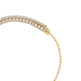 A macro studio photograph showing the structural junction of the Escada Diana bracelet, where the dual-row clear crystal tennis cup strand smoothly interfaces with the open-link yellow gold-plated chain track.