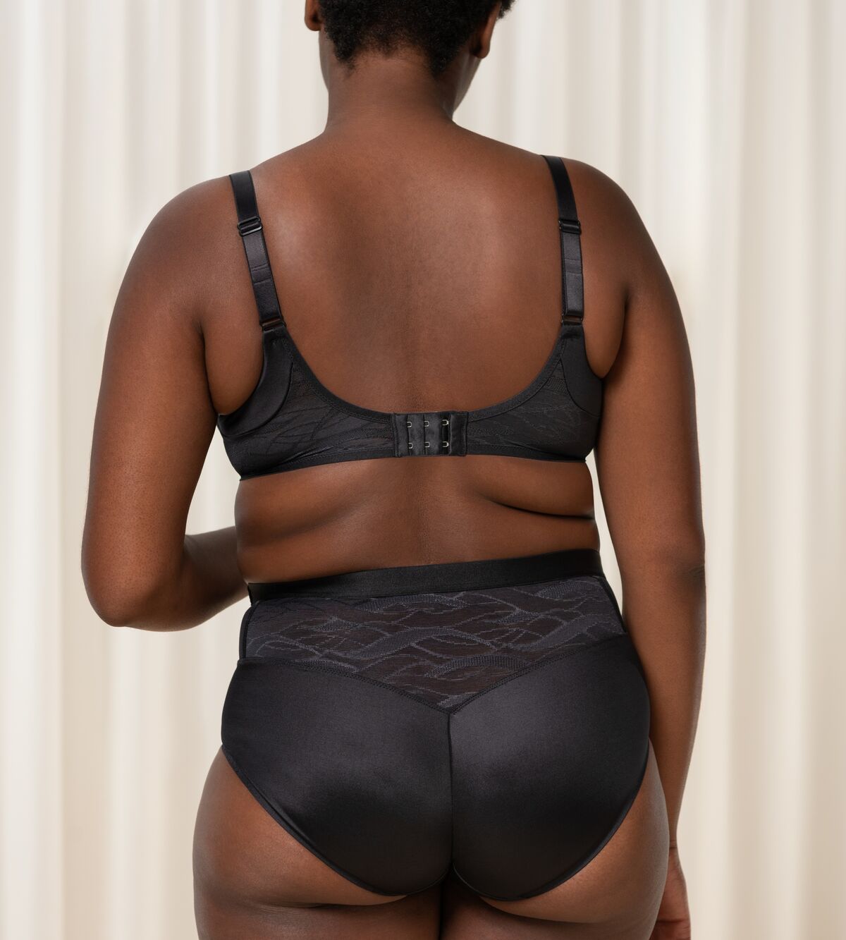 Triumph Airy Sensation black padded bra second model back view, showing breathable mesh wings and adjustable straps. Shop the latest Online.
