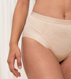 Triumph Airy Sensation nude beige maxi panty model clos-up view, showing fit and detailing the shaping mesh panels. Shop Now at Blue Salon Qatar