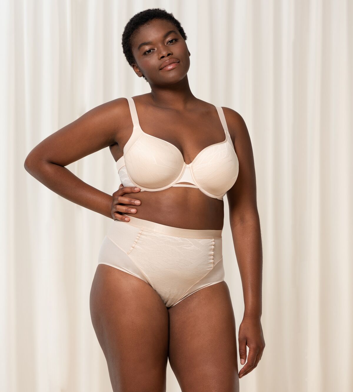 Triumph Airy Sensation nude beige maxi panty second model full front view, with shaping mesh panels. Shop Now at Blue Salon Qatar