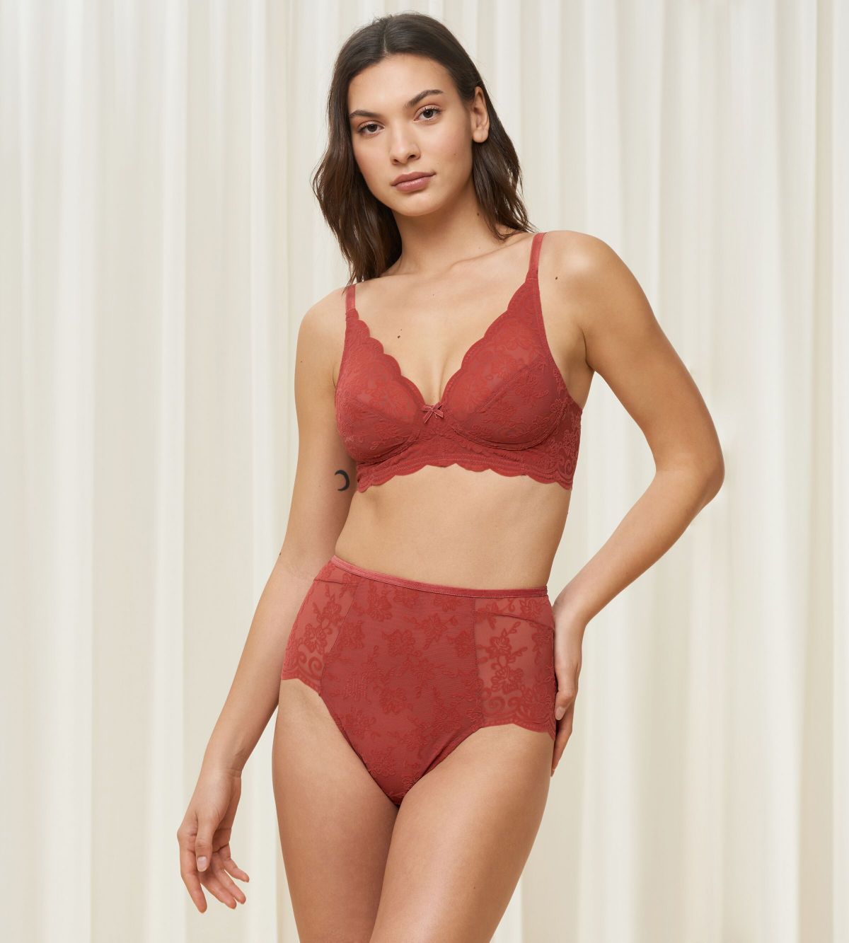 Triumph Amourette 300 Rococo non-wired bra in Mannish red model full front view, showcasing the intricate floral lace and wireless cup design. Order Online Today