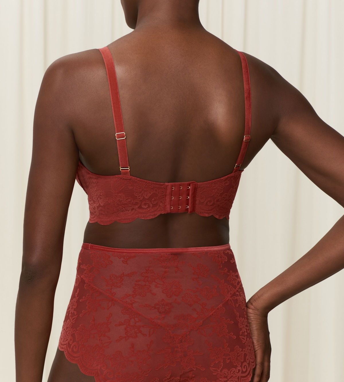 Triumph Amourette 300 Rococo non-wired bra in Mannish red second model back view, showcasing the intricate floral lace and adjustable straps. Order Online Today