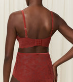 Triumph Amourette 300 Rococo non-wired bra in Mannish red second model back view, showcasing the intricate floral lace and adjustable straps. Order Online Today