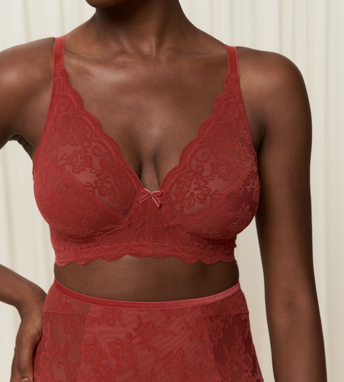 Triumph Amourette 300 Rococo non-wired bra in mannish red second model close-up view, detailing the intricate floral lace and fit. Order Online Today