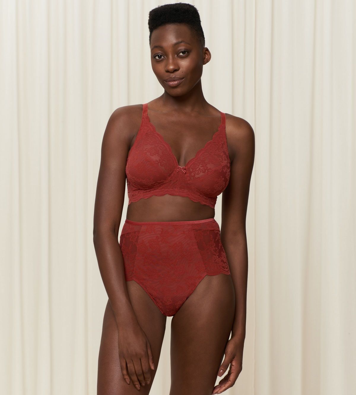 Triumph Amourette 300 Rococo non-wired bra in Mannish red second model full front view, showcasing the intricate floral lace and wireless cup design. Order Online Today