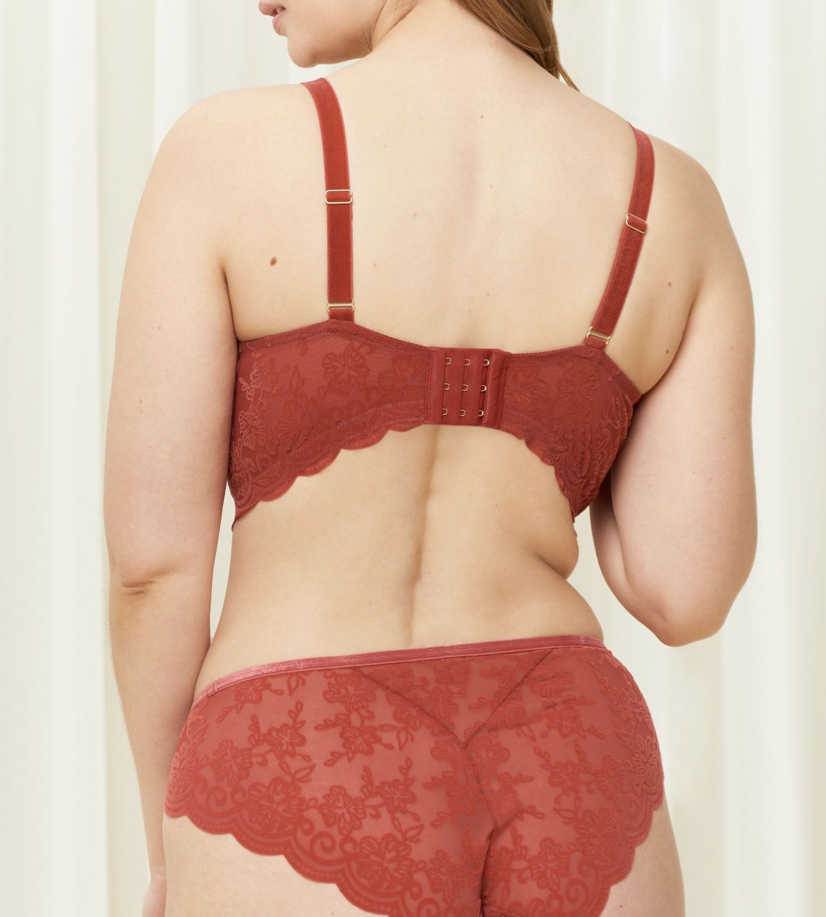 Triumph Amourette 300 Rococo non-wired bra in Mannish red third model back view, showcasing the intricate floral lace and adjustable straps. Order Online Today