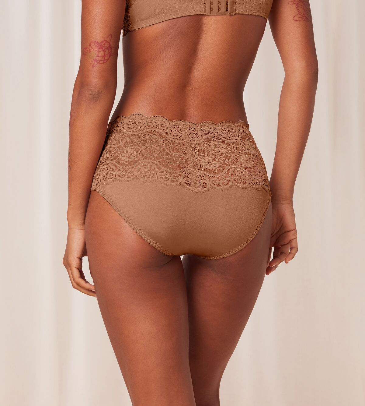 Triumph Amourette 300 maxi panty in Toast beige model back view, showing fit with floral lace details and high-waist cut. Shop Now Online
