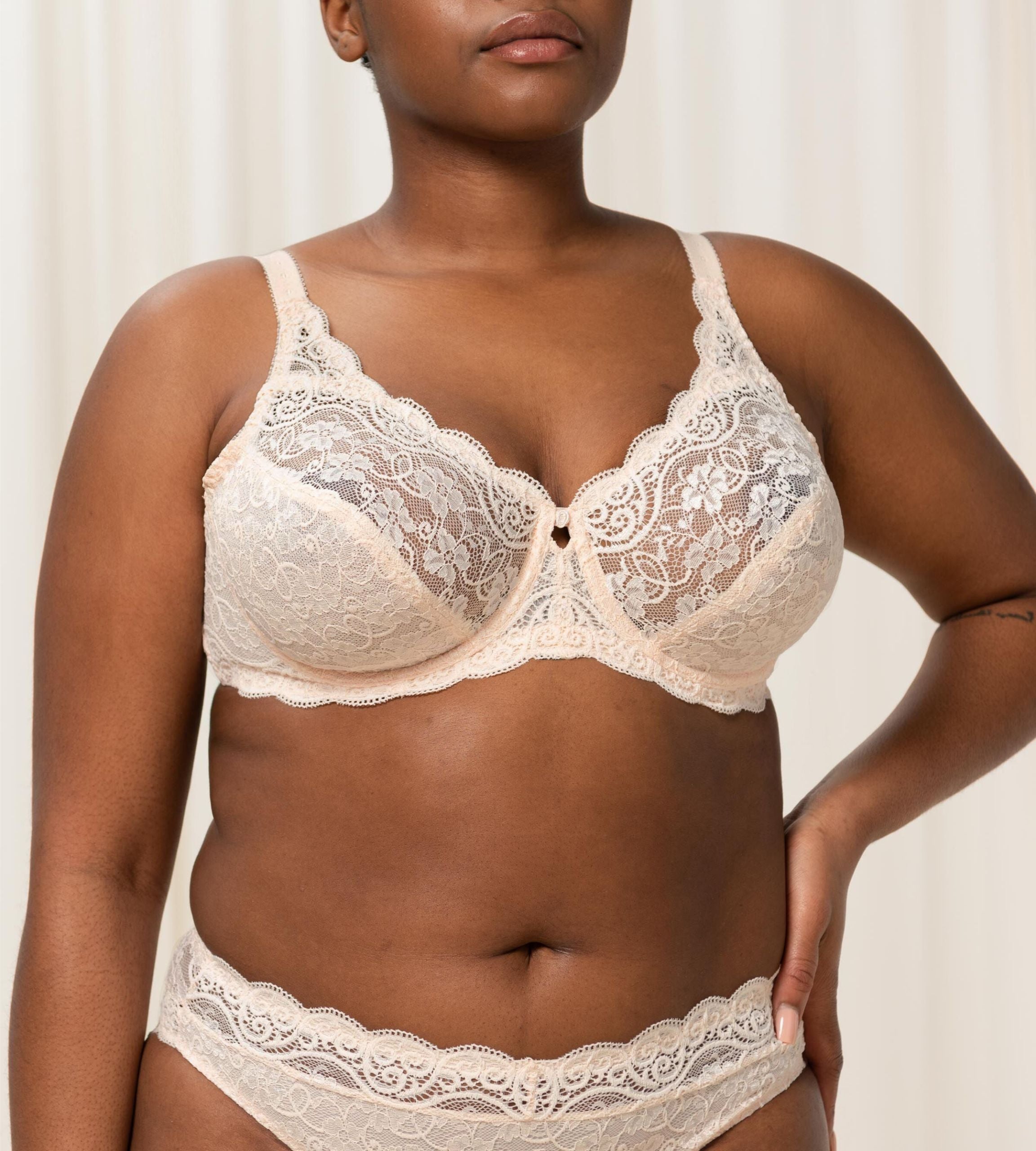 Triumph Amourette 300 wired bra in light beige third model front view, featuring unpadded floral lace cups. Available Now Online