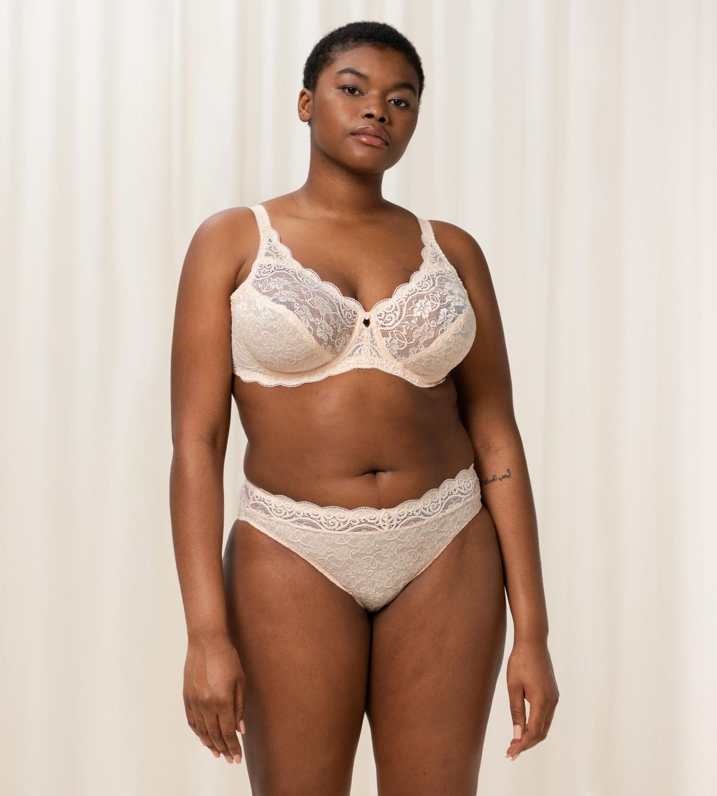 Triumph Amourette 300 wired bra in light beige third model full front view, featuring unpadded floral lace cups. Available Now Online