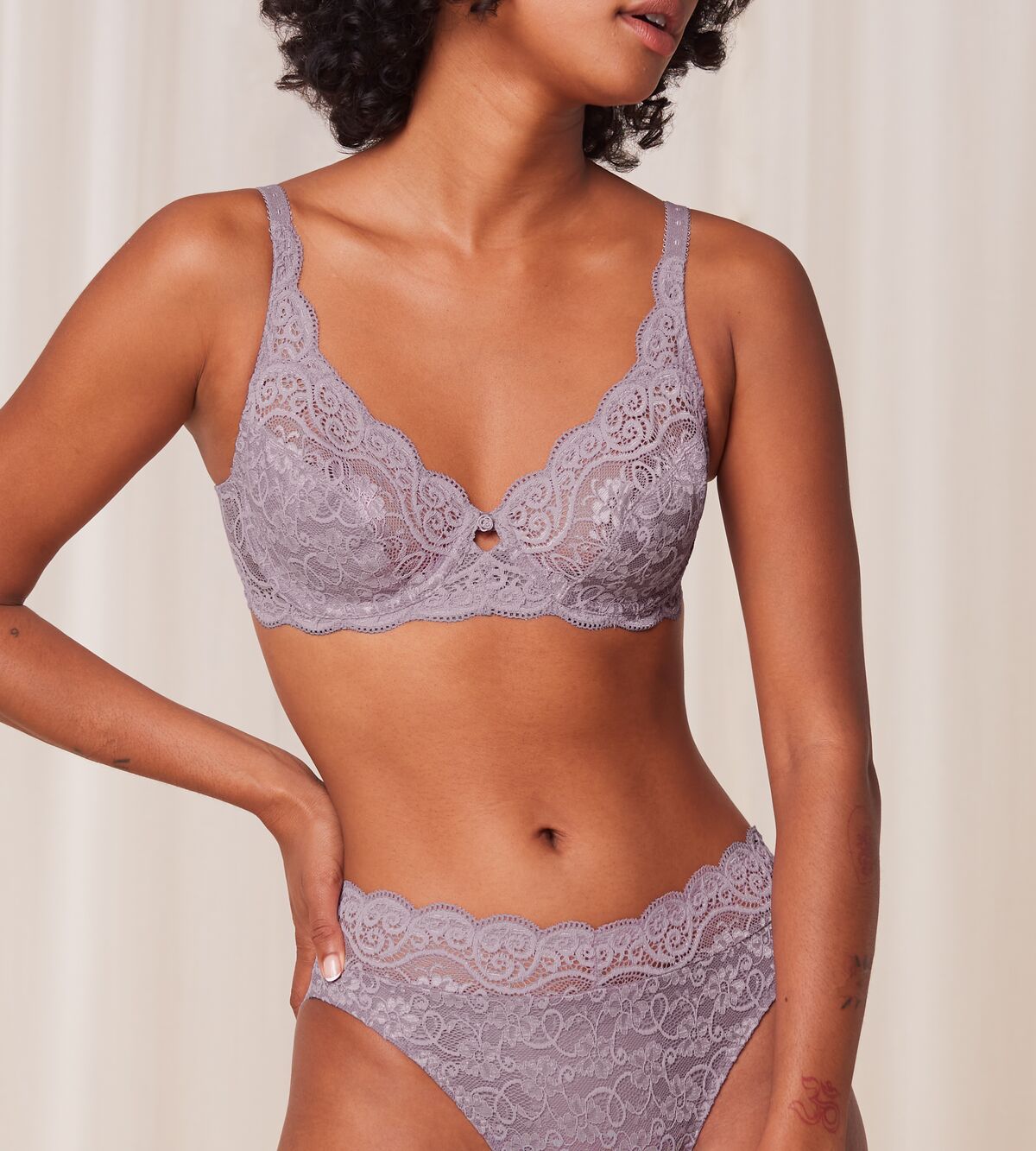 Triumph Amourette 300 wired bra in purple model front view, featuring unpadded floral lace cups and supportive underwiring. Find Online Today