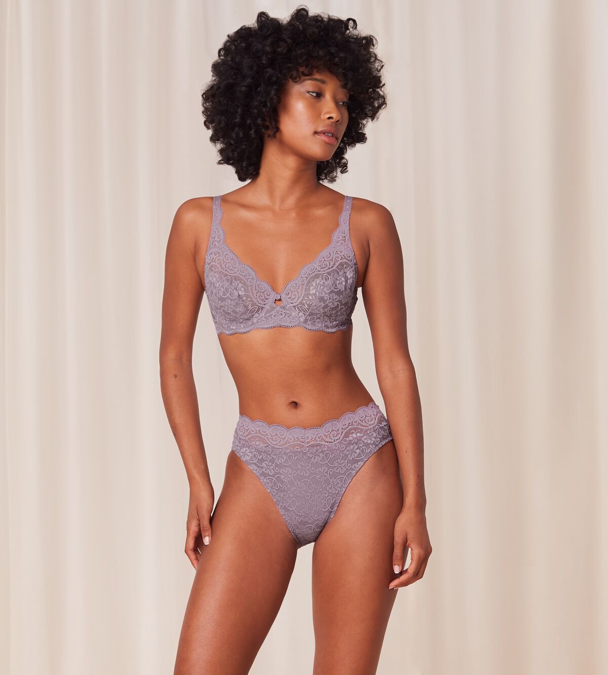 Triumph Amourette 300 wired bra in purple model full front view, featuring unpadded floral lace cups and supportive underwiring. Find Online Today