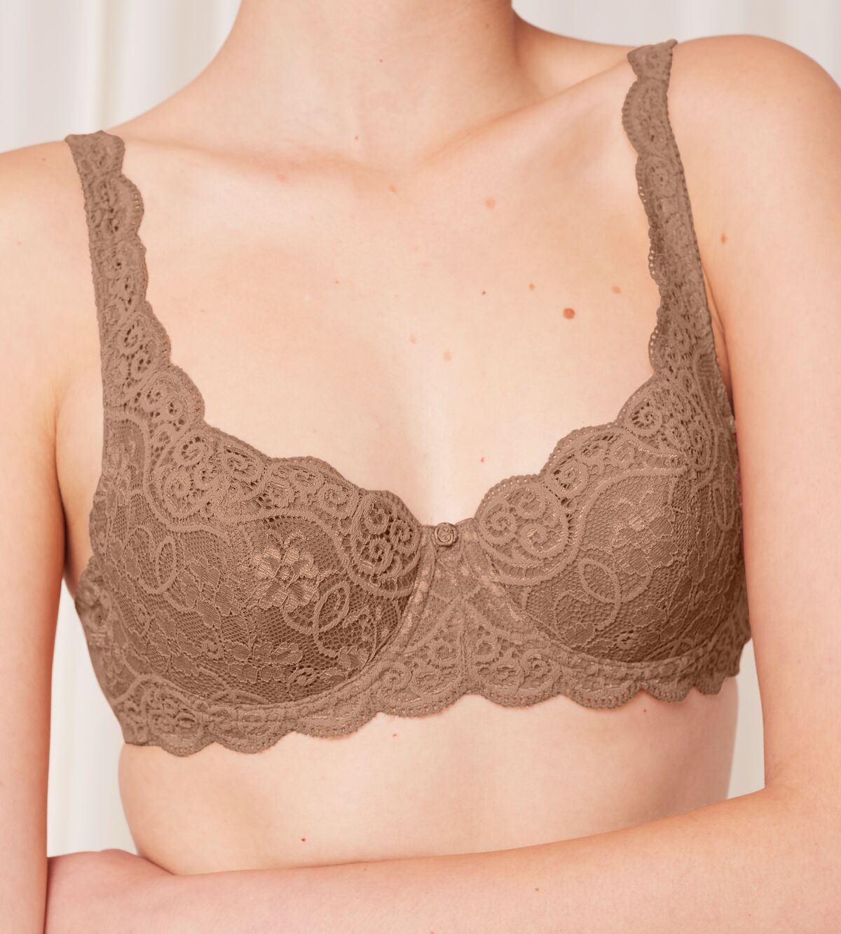 Triumph Amourette 300 wired padded bra in Toast model close-up view, detailing lace-overlaid padded cups and supportive underwiring. Available Now at Blue Salon Qatar