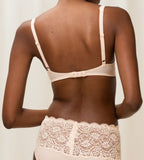 Triumph Amourette 300 wired padded bra in light beige second model back view, showing adjustable straps and the floral lace overlay and smooth padded cups. Available for Online Purchase