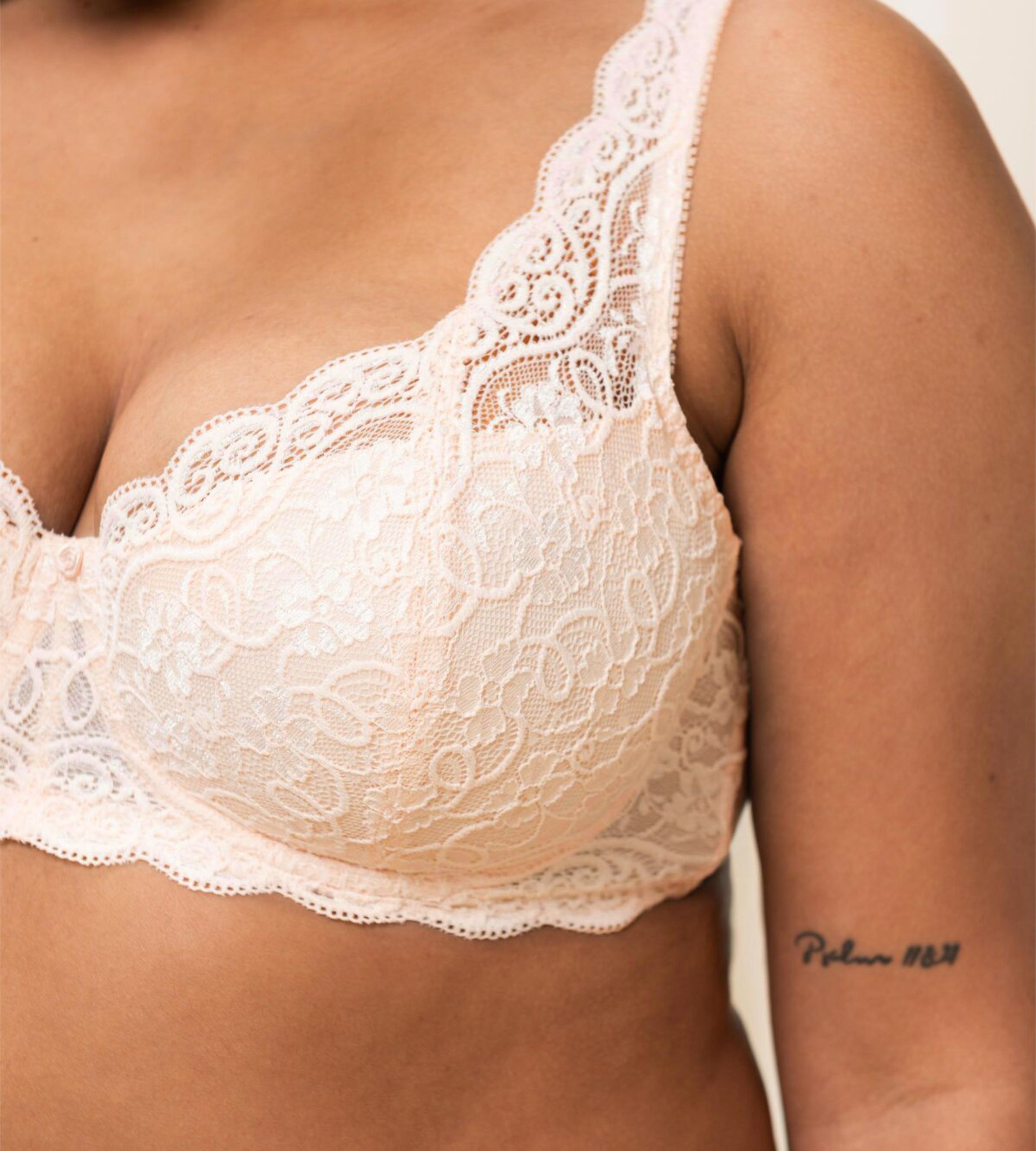 Triumph Amourette 300 wired padded bra in light beige second model close-up view, detailing the floral lace overlay and smooth padded cups. Available for Online Purchase