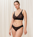Triumph Amourette Charm Brazilian panties in black lace model full front view, showing the cheeky cut and flat-seam design. Shop Online at Blue Salon Qatar