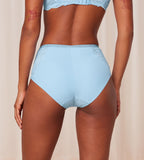 Triumph Amourette Charm T maxi panty in light blue model back view, showing the high-waist lace design and seamless back finish. Available for Online Purchase