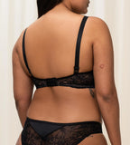 Triumph Amourette Charm black wired bra second model back view, showing adjustable straps and featuring intricate floral lace. Shop Now Online