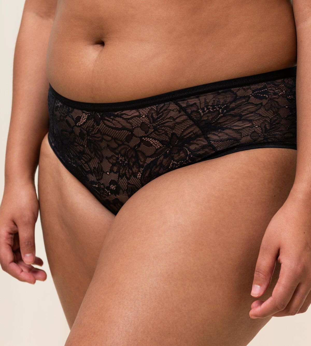 Triumph Amourette Charm maxi panties in black second model close-up view, showing fit and details of the floral lace design. Shop Now Online