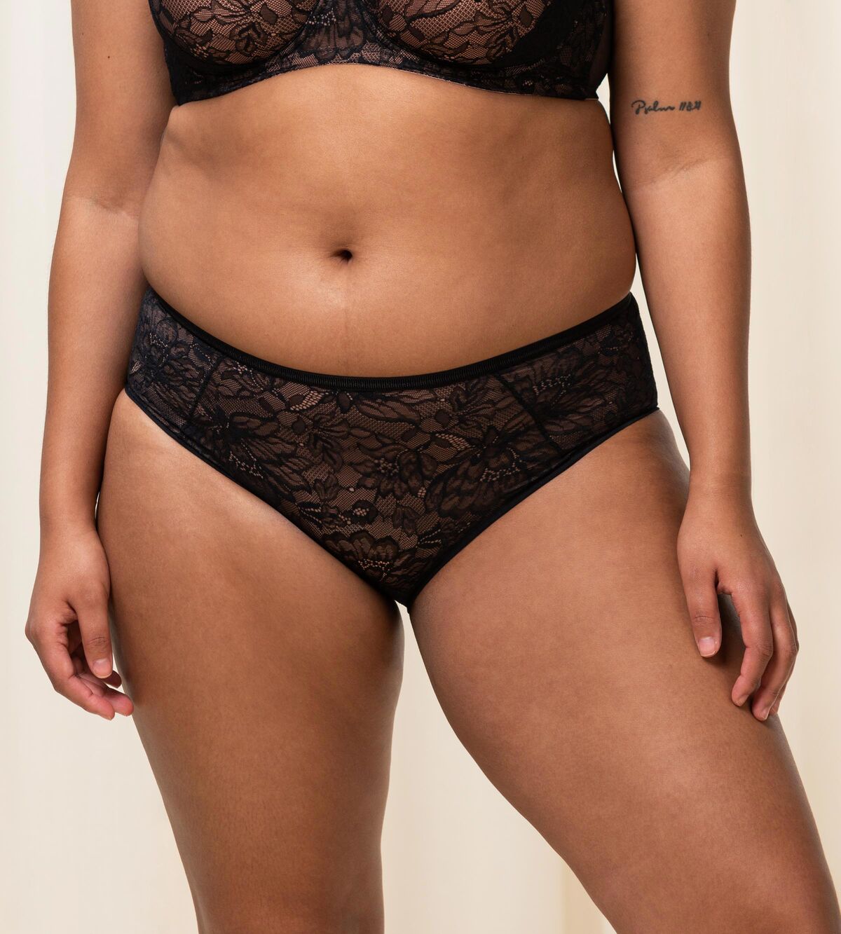 Triumph Amourette Charm maxi panties in black second model front view, showing the floral lace front. Shop Now Online