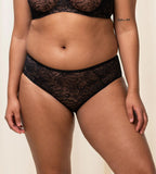 Triumph Amourette Charm maxi panties in black second model front view, showing the floral lace front. Shop Now Online