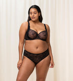 Triumph Amourette Charm maxi panties in black second model full front view, showing the floral lace front. Shop Now Online