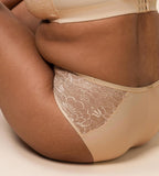 Triumph Amourette Charm maxi panties in light beige showing second model sitting view, featuring the high-waist lace front and smooth microfiber back. Order Online Today