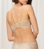 Triumph Amourette Charm non-wired bra in light beige model back view, showing the floral lace design and adjustable straps. Available for Online Purchase