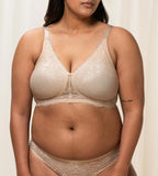 Triumph Amourette Charm non-wired bra in light beige second model front view, showing the floral lace cups and plunge neckline. Available for Online Purchase