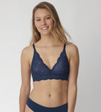 Triumph Amourette Charm non-wired bra in navy blue model front view, showcasing the floral design and the intricate lace plunge neckline. Find Now Online