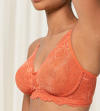 Triumph Amourette Charm non-wired bra in orange model side view, showing fit and floral stretch lace. Shop Online Today