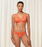 Triumph Amourette Charm non-wired bra in orange third model full front view, featuring floral stretch lace and a plunging neckline. Shop Online Today