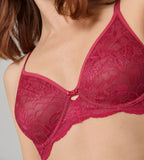 Triumph Amourette Charm wired bra in Raspberry Wine model close-up view, detailing the deep red floral lace and supportive wired cups. Find Now Online
