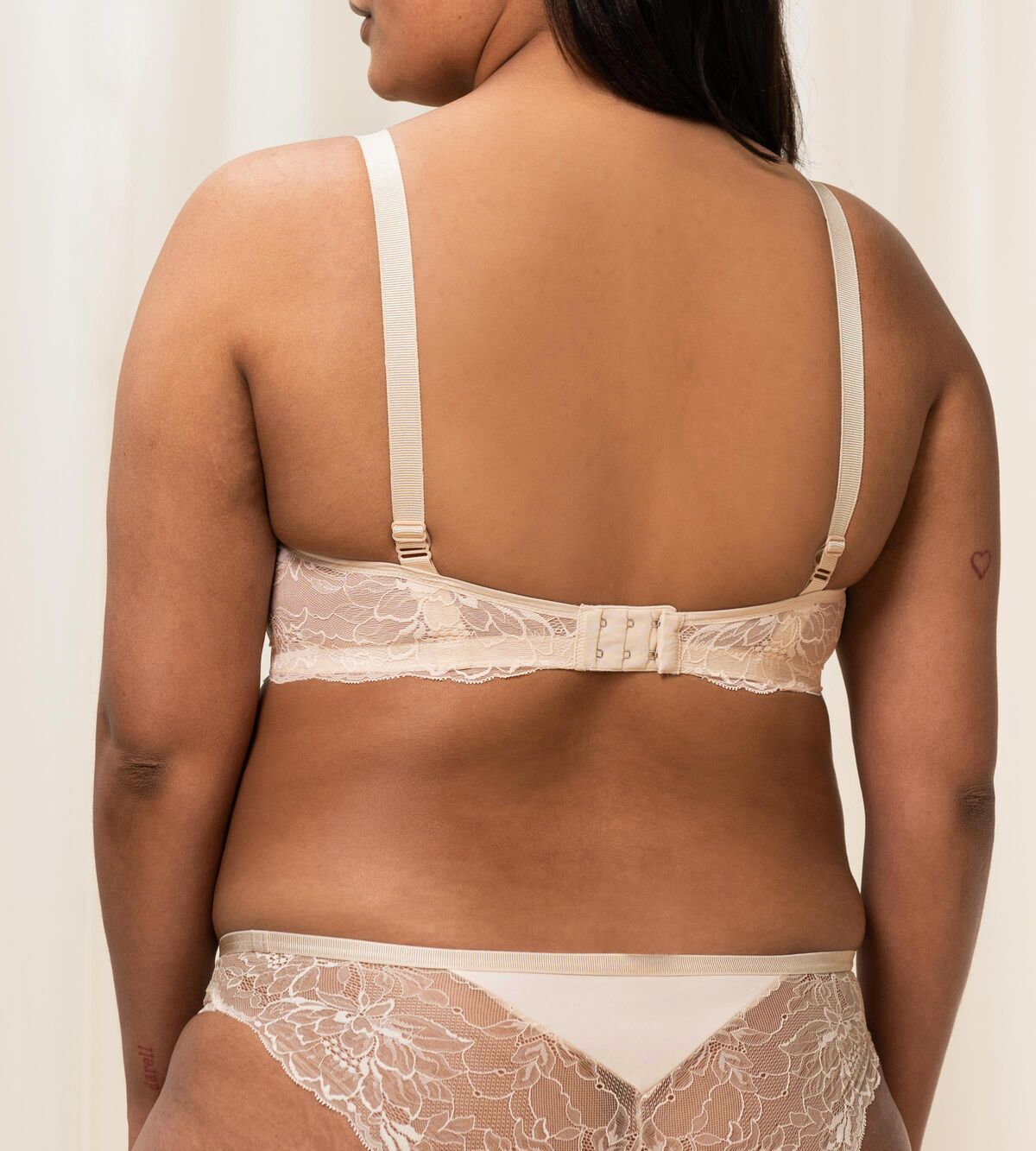 Triumph Amourette Charm wired bra in light beige second model back view, showing adjustable straps and the floral lace. Available Now Online