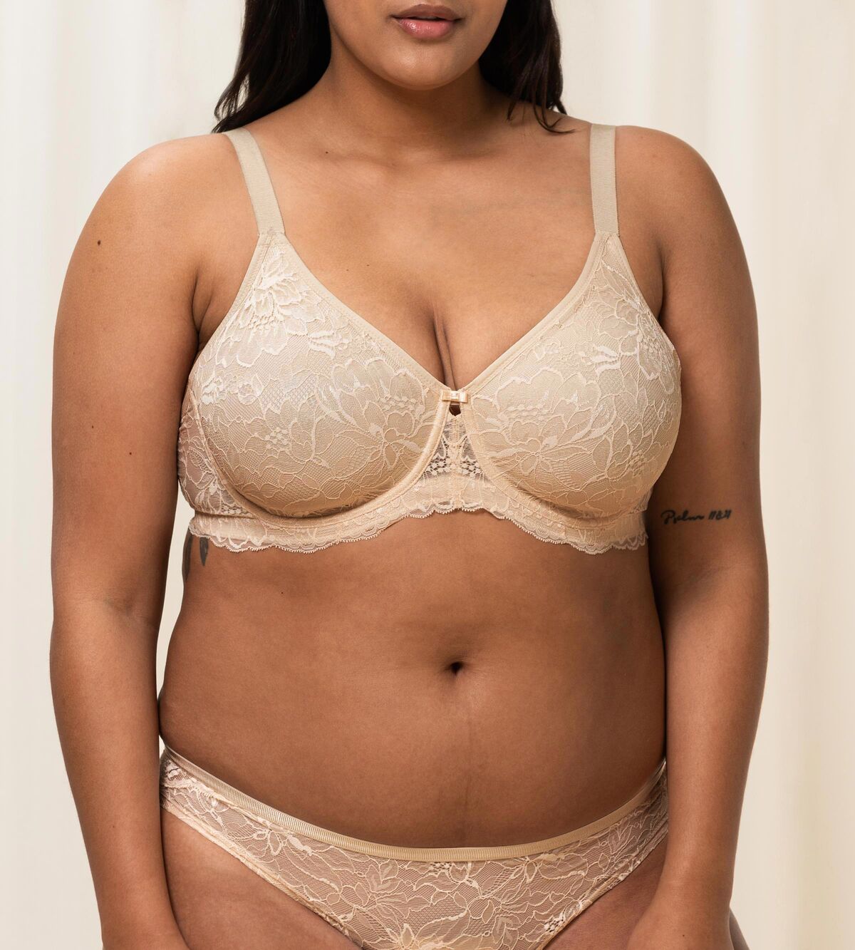 Triumph Amourette Charm wired bra in light beige second model front view, showing the floral lace cups and supportive underwired construction. Available Now Online