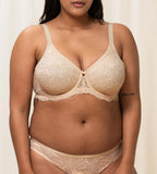Triumph Amourette Charm wired bra in light beige second model front view, showing the floral lace cups and supportive underwired construction. Available Now Online