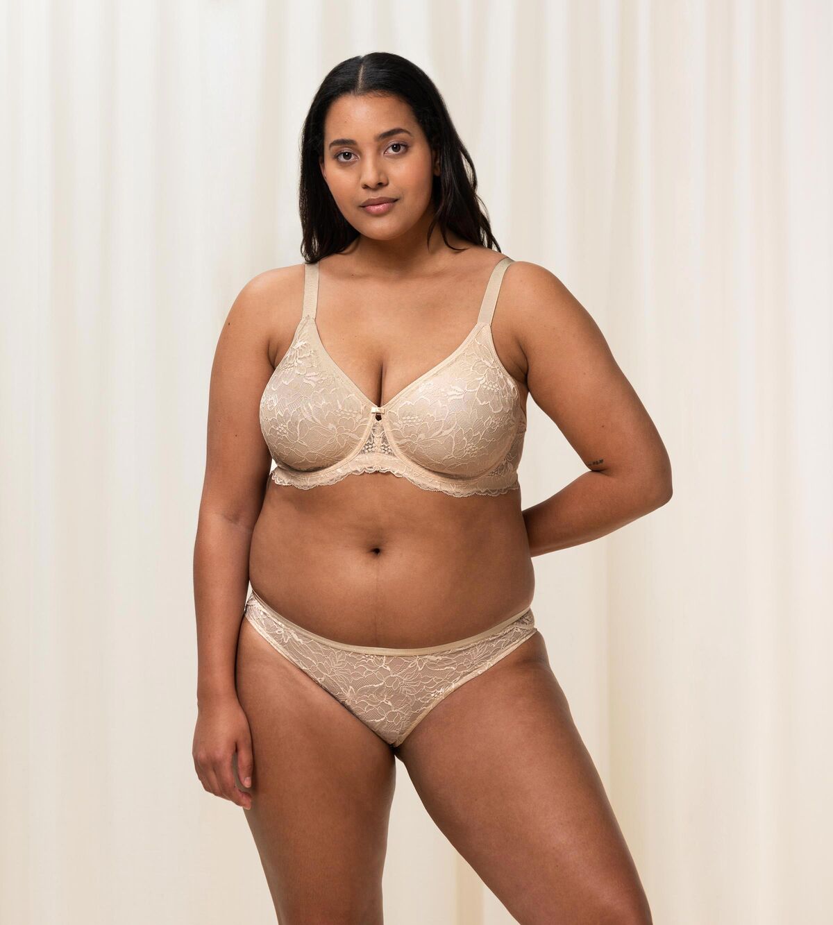 Triumph Amourette Charm wired bra in light beige second model full front view, showing the floral lace cups and supportive underwired construction. Available Now Online