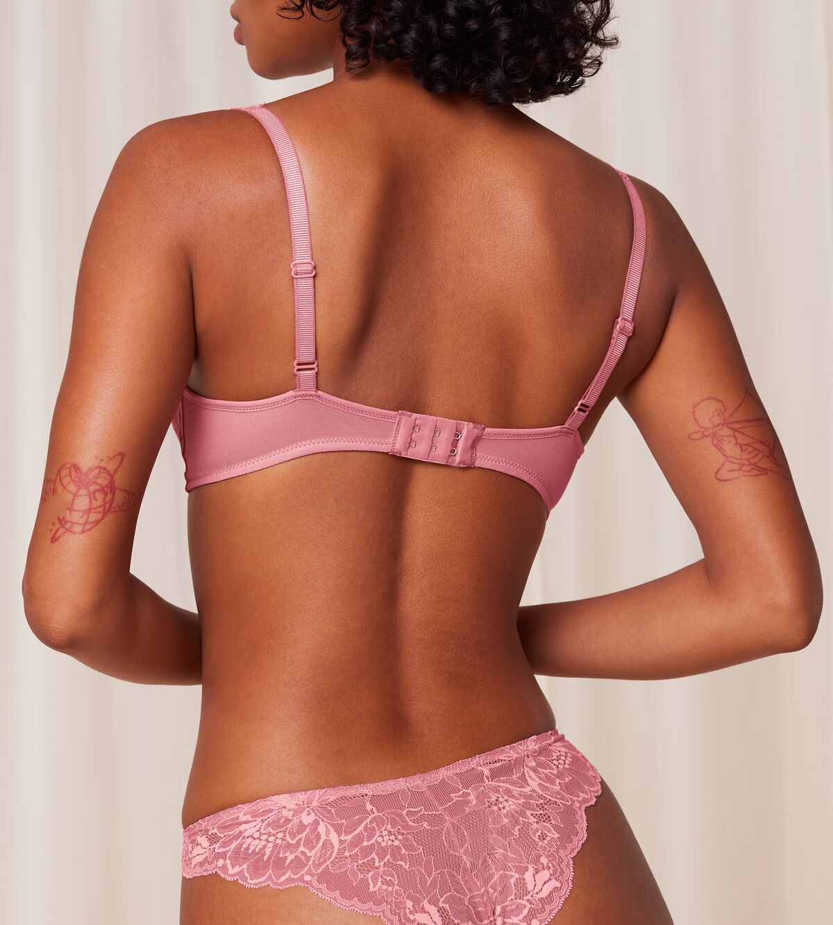 Triumph Amourette Charm wired padded bra in pink model back view, showcasing adjustable straps. Order Online Today