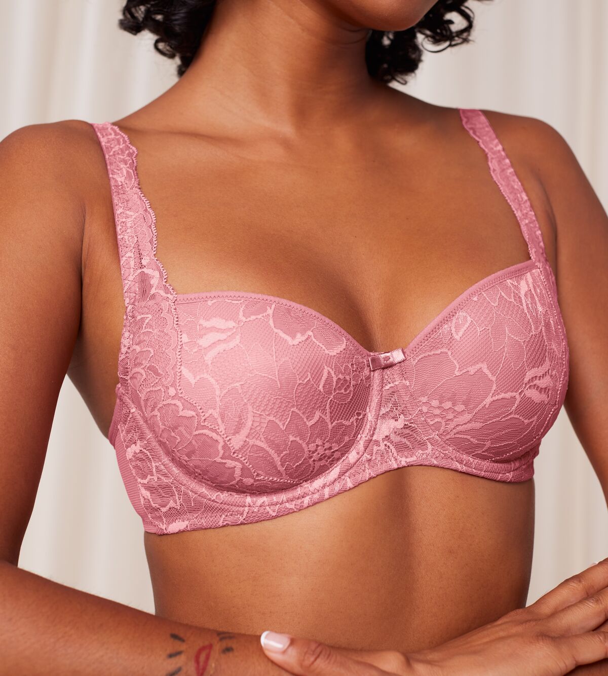 Triumph Amourette Charm wired padded bra in pink model clos-up view, detailing the lace-covered cups and supportive underwired design. Order Online Today