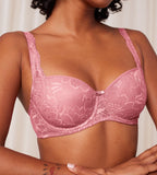 Triumph Amourette Charm wired padded bra in pink model clos-up view, detailing the lace-covered cups and supportive underwired design. Order Online Today