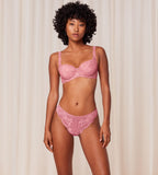 Triumph Amourette Charm wired padded bra in pink model full front view, showcasing the lace-covered cups and supportive underwired design. Order Online Today